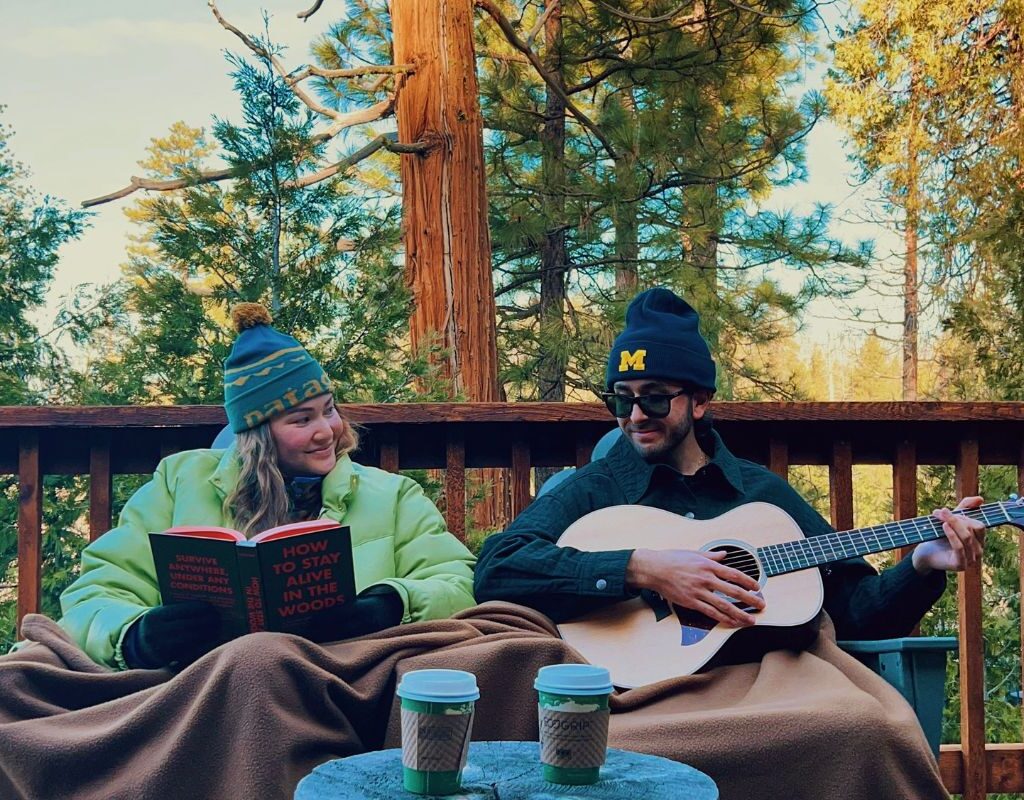Couple on their cabin deck in winter in Yosemite.