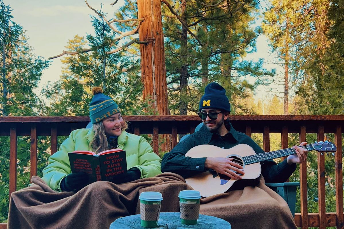 Couple on their cabin deck in winter in Yosemite.